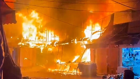 Flames billow after a fire broke out at Shiv Market opposite the Jammu Railway Station, in Jammu, Monday, Oct. 26, 2026.