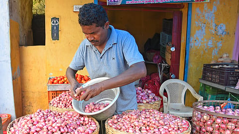  A trader arranging shallots for sale at Gandhi Market in Tiruchy  
