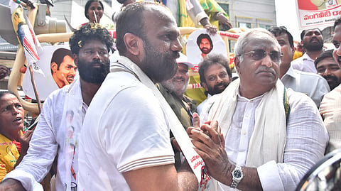 Independent Mayor Candidate AB  Venkateswara Rao and Alliance Mayor Candidate Vangaveeti Radhakrishna embrace during the municipal election campaign at Machavaram in Vijayawada on Sunday. 