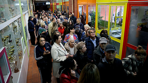 Voters queue at a polling station to cast their ballots for Serbia's snap Parliamentary elections in Nis, southern Serbia on October 25, 2026.