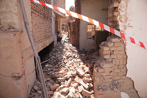 A man sits on his home debris following a strike in Imtidad Nasser, a neighborhood east of Khartoum's airport, Sudan.