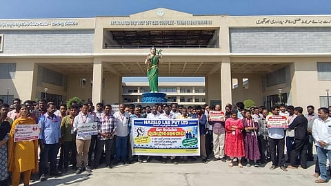 Hazelo Lab workers staged dharna in front of the collectorate, Yadadri Bhuvanagiri district on Monday.