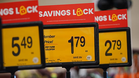 Savings are advertised on signs at a grocery store in the Dallas suburb of Richardson, Texas, Friday, Oct. 23, 2026.