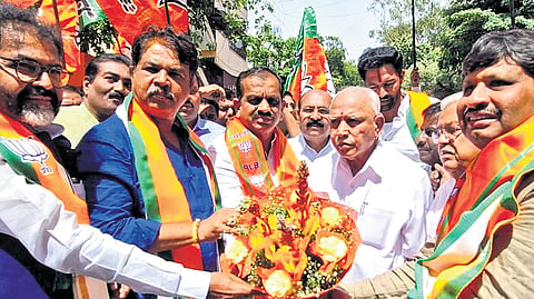 BJP leaders, including LoPs Chalavadi Narayanaswamy and R Ashoka, Chitradurga MP Govind Karjol, former CM BS Yediyurappa and others celebrate with the newly elected NDA MLCs, at the BJP office in Bengaluru on Wednesday. 