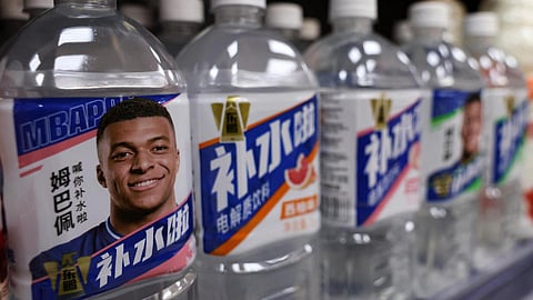 Bottled drinks by Eastroc Beverage with images of French soccer player Kylian Mbappe are displayed on a shelf at a store, in Beijing, China on October 27, 2026. 