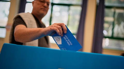 A voter casts his ballot at a polling station during Israel's general election in Tel Aviv, Israel, Tuesday, Oct. 27, 2026. 