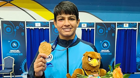 Wrestler Tanu Sharma celebrates with the bronze medal