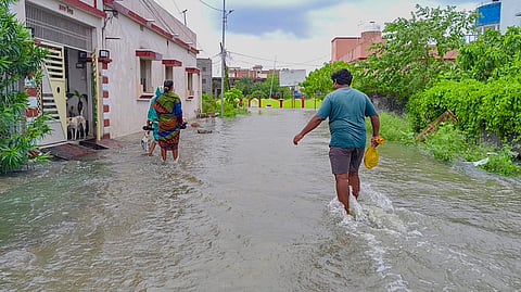 People move on an inundated area amid flash floods triggered by Cyclone 'Arnab', in Berhampur, Odisha, Thursday, Oct. 29, 2026. 