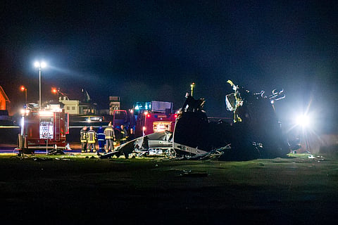 First responders stand next to the wreckage of an Italian CH-47 Chinook helicopter crashed in Brcko, Bosnia, Thursday, Oct. 29, 2026. 