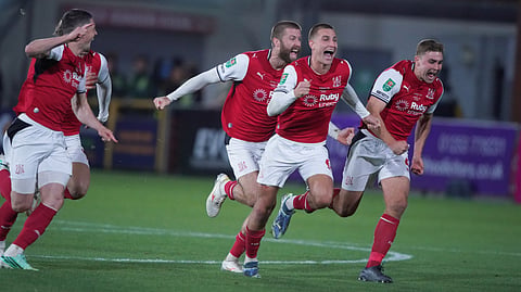 Fleetwood's players celebrate after winning a penalty shootout during the English League Cup soccer match between Fleetwood Town and Arsenal in Fleetwood, England, Tuesday, Oct. 27, 2026.
