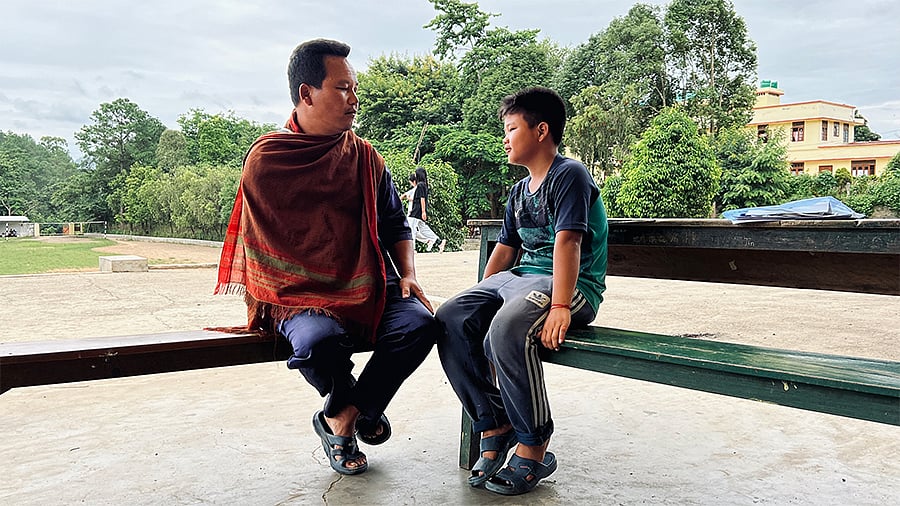 At St Mary’s relief camp, Mangmimkap, sitting beside his father, recalls the night he saw an entire village being burnt. 