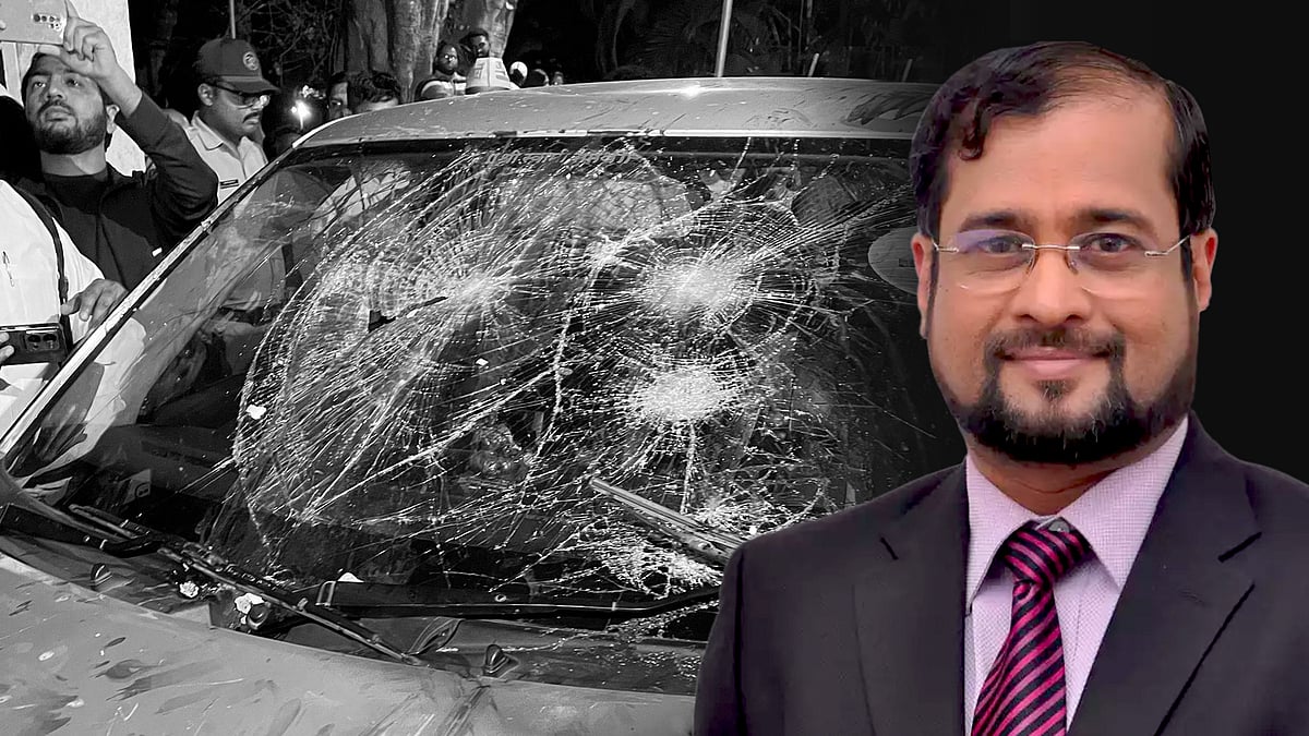 Journalist Nikhil Wagle with a picture of his damaged vehicle.