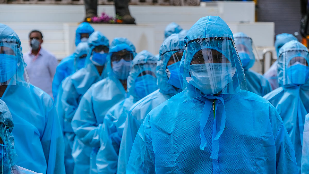 Healthcare workers wearing PPE and face shields.