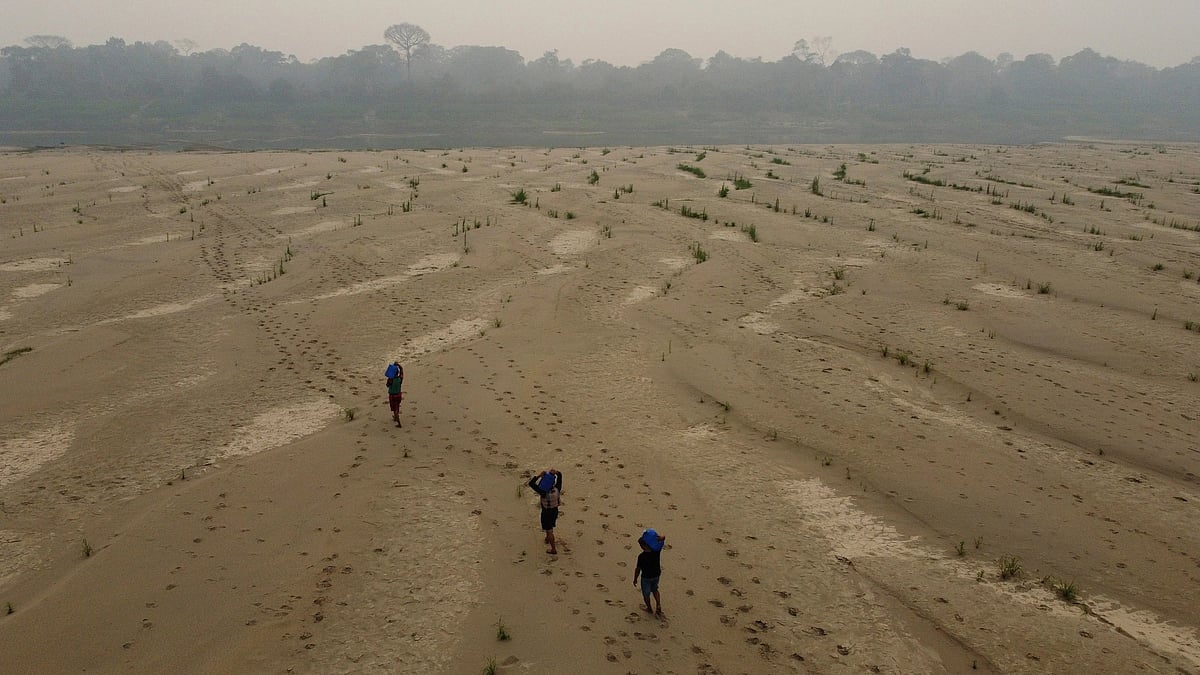 Residents transport drinking water along the dry Madeira River in Brazil. (AP Photo/Edmar Barros, File)