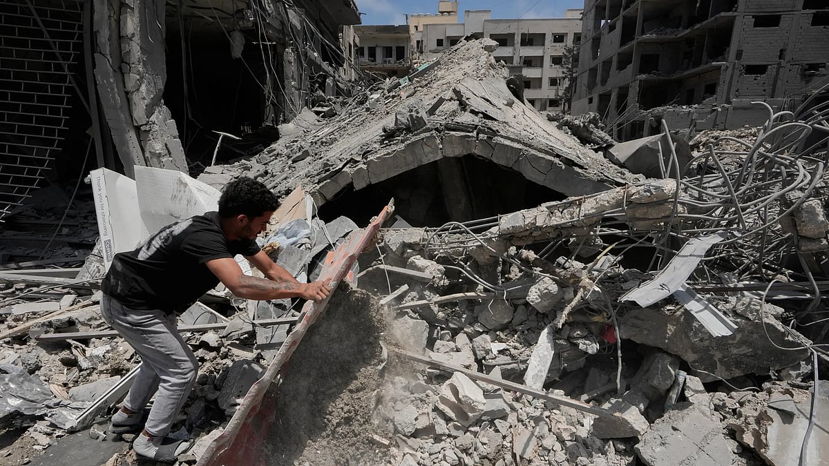 A man removes debris from a building that was hit in an Israeli airstrike in Tyre, Lebanon. (AP Photo/Mohammed Zaatari)