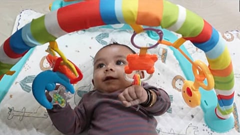 A toddler seeks the mercy of well-wishers
