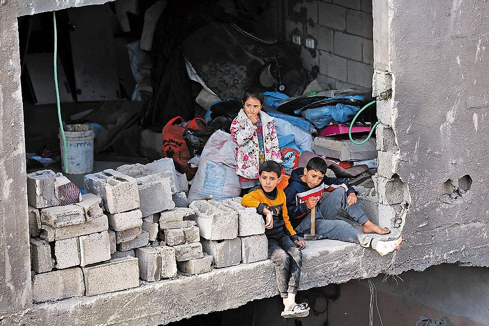 Getty Images : Children look on as civil defence teams conduct rescue operations following an Israeli attack in Gaza