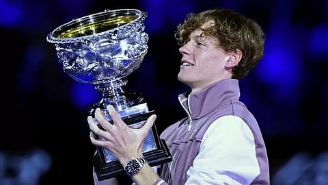 Jannik Sinner of Italy holds aloft the trophy after winning the Australian Open 2024 mens singles 

