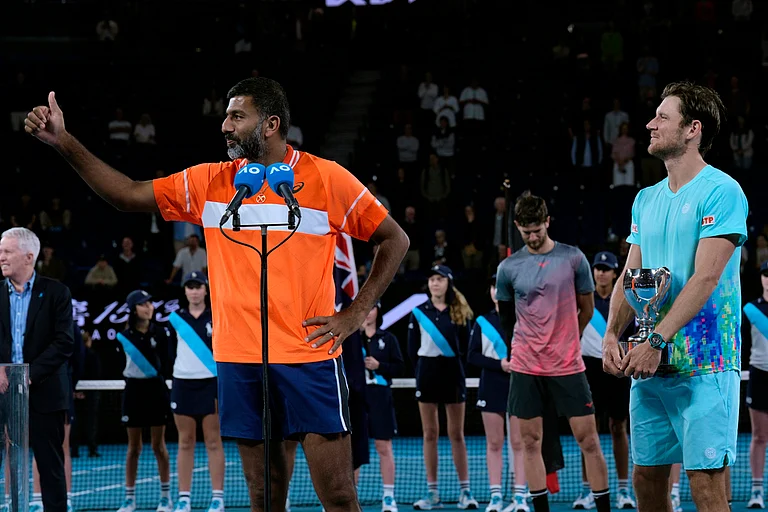 Rohan Bopanna, left, of India and Matthew Ebden of Australia react after receiving their trophy after defeating Simone Bolelli and Andrea Vavassori of Italy in the men's doubles final at the Australian Open tennis championships at Melbourne Park, Melbourne, Australia, Saturday, Jan. 27, 2024. - (AP Photo/Andy Wong)