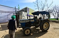 Beyond The Border: What The Home Of A Farmer Killed Amid Protests Says Tribhuvan Tiwari/Outlook India : Shubhkaran's tractor parked outside his house, against a poster with his photograph in Baloh village.