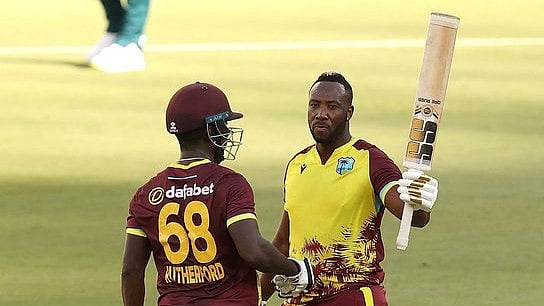 ICC Photo : Andre Russell (right) smashed 29-ball 71 against Australia.