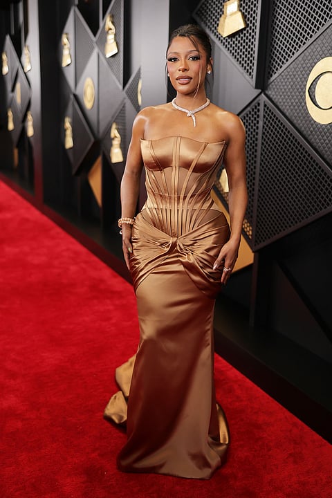 Victoria Monét appeared elegant in a well-defined copper mermaid dress designed by Versace.