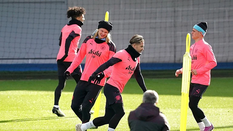 Manchester City's Erling Haaland, second left, Jack Grealish and Phil Foden, right, attend a training session at the City Football Academy in Manchester, ahead of their UEFA Champions League 2023-24 tie against Copenhagen. - Photo: Martin Rickett/PA via AP