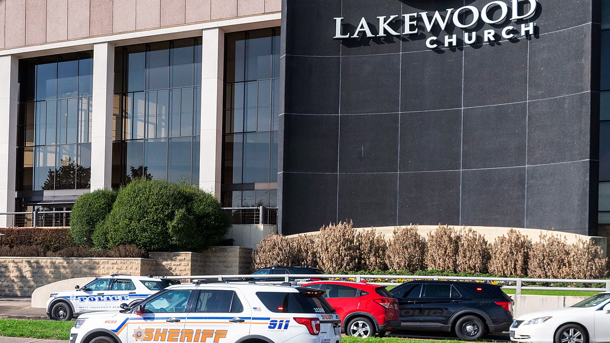 Emergency vehicles line the feeder road outside Lakewood Church during a reported active shooter event. - AP