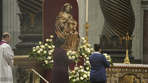 Ángeles Lopez, right, and Ines Candela bring flowers to the main altar where the relics of new Argentine Saint María Antonia de Paz y Figueroa also known as "Mama Antula" are placed in St. Peter's Basilica at The Vatican.