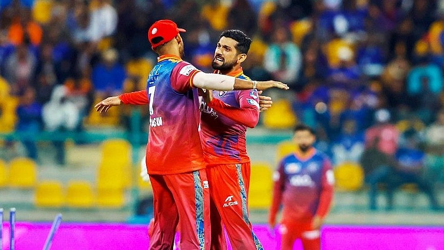 X/ @ILT20Official : Dubai Capitals' Sikandar Raza (R) celebrating after taking a wicket in International League T20 2024.