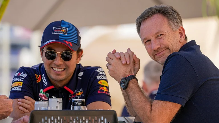 Red Bull team principal Christian Horner, right, chats with Red Bull driver Sergio Perez of Mexico at the pits during Formula One pre season test at the Bahrain International Circuit in Sakhir, Bahrain, Wednesday, Feb. 21, 2024.
- (AP Photo/Darko Bandic)