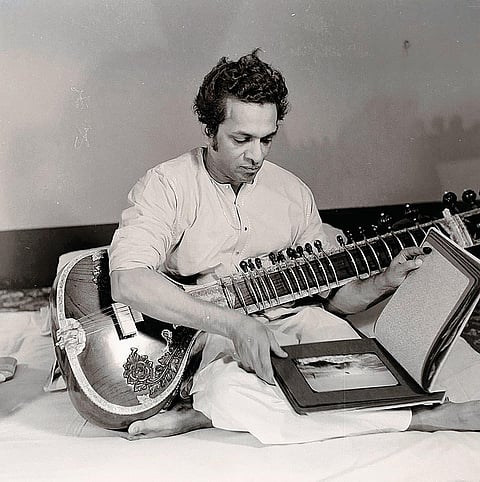 Pandit Ravi Shankar admiring Tatya’s photo album