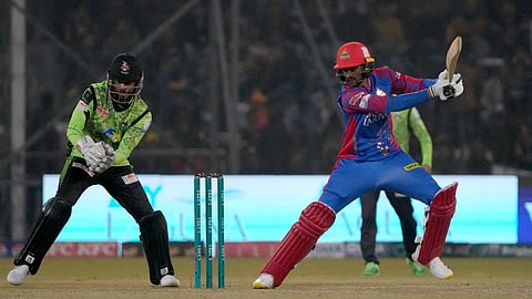 Karachi Kings' Shoaib Malik, right, plays a shot during their Pakistan Super League match against Lahore Qalandars in Lahore on February 24, 2024.