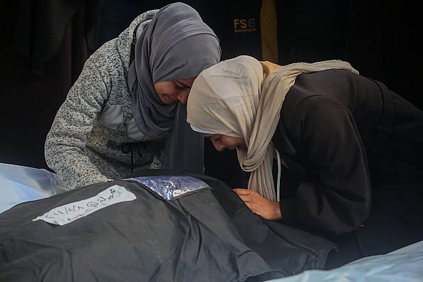 People mourn as they receive the dead bodies of victims of an Israeli strike (representative image) - Getty Images
