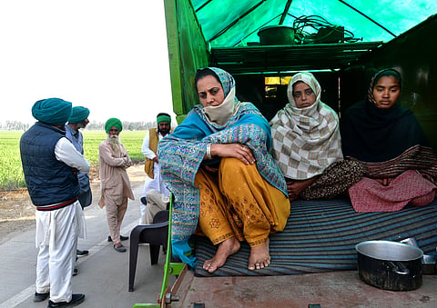 Shubhkarana's aunty (in front) and two sisters sit insidea tractor at Khanauri border.