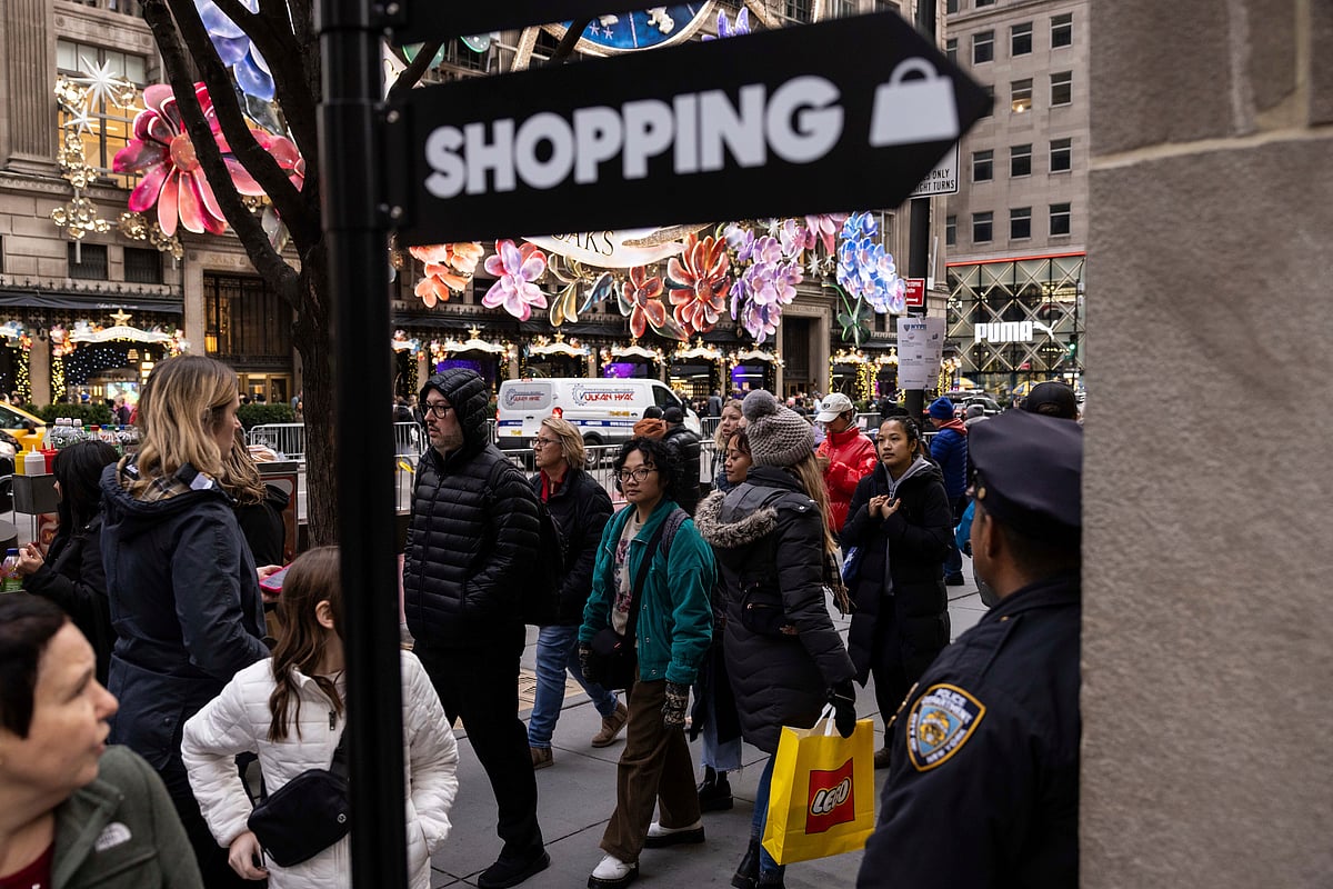 Yuki IWAMURA/ AP : Shoppers walk on Fifth Avenue in New York City.