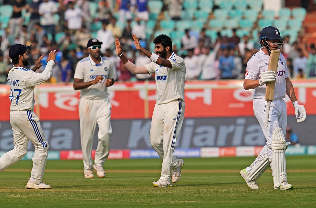 AP Photo/Manish Swarup : Jasprit Bumrah, center, celebrates the wicket of England's wicketkeeper Jonathan Bairstow, right, on the second day of the second cricket test match between India and England in Visakhapatnam.