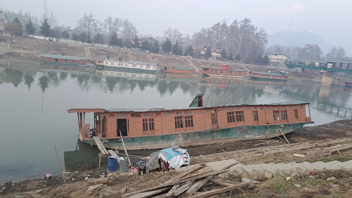 A houseboat in a waterbody in Kashmir with depleted water level.