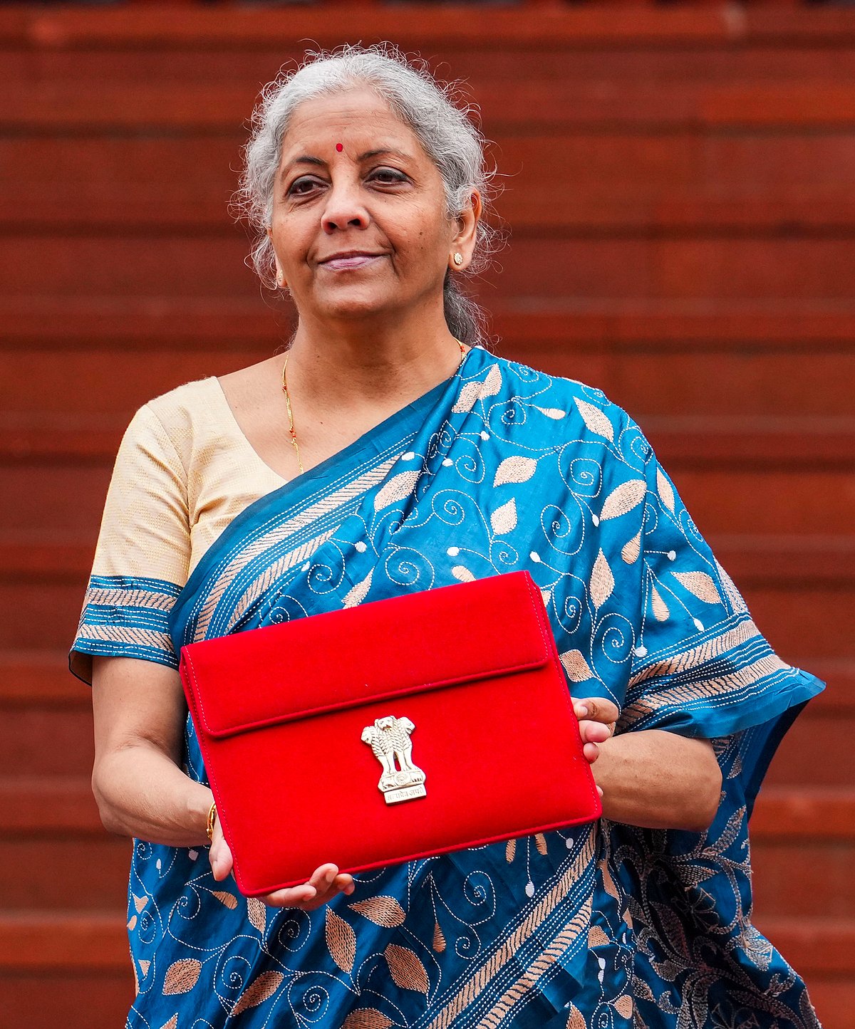 PTI : Finance Minister Nirmala Sitharaman upholds her digital tradition by presenting a paperless Budget, carrying a tablet in a traditional 'bahi-khata' style pouch as she heads to Parliament.
