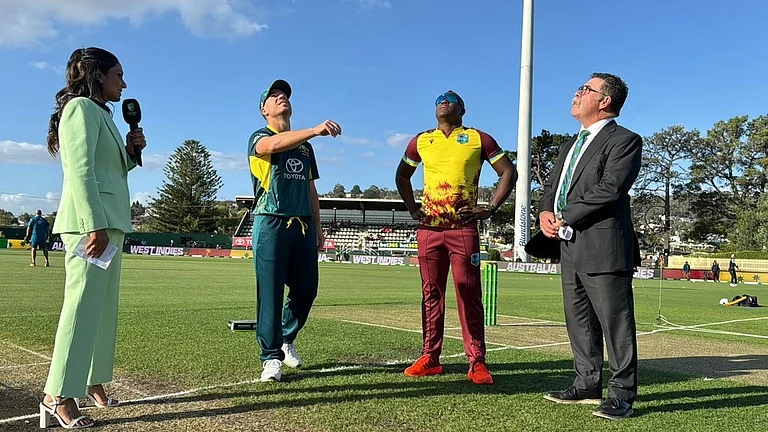 Stand-in Australia captain David Warner at the toss alongside West Indies' Rovman Powell for the first T20I in Hobart. - X/Windies Cricket