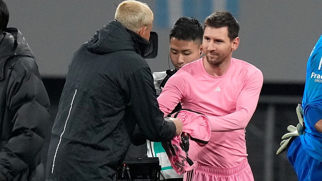 Inter Miami's Lionel Messi, right gives his jersey to a Vissel Kobe's official after their friendly soccer match at the National Stadium, Wednesday, Feb. 7, 2024, in Tokyo, Japan.  - (AP Photo/Eugene Hoshiko)