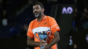 (Photo: AP) : Rohan Bopanna of India holds his trophy after he and partner Matthew Ebden of Australia defeated Simone Bolelli and Andrea Vavassori of Italy in the men's doubles final at the Australian Open 2024 at Melbourne Park, Melbourne on January 27, 2024.