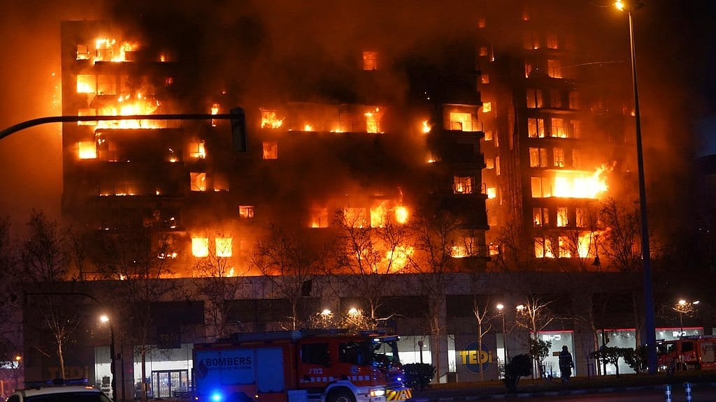 AP : A housing block burns in Velancia.