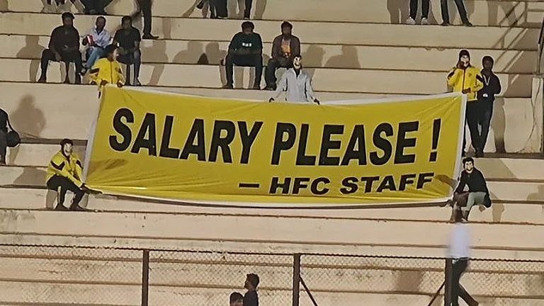Employees unfurl the banner at the stadium. - Photo - X/IFTWC