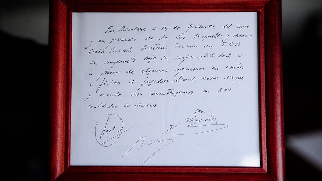 A framed copy of the napkin linking the 13-year-old Lionel Messi to FC Barcelona. - AP Photo/Manu Fernandez, File