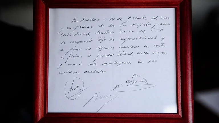 A framed copy of the napkin linking the 13-year-old Lionel Messi to FC Barcelona. - AP Photo/Manu Fernandez, File