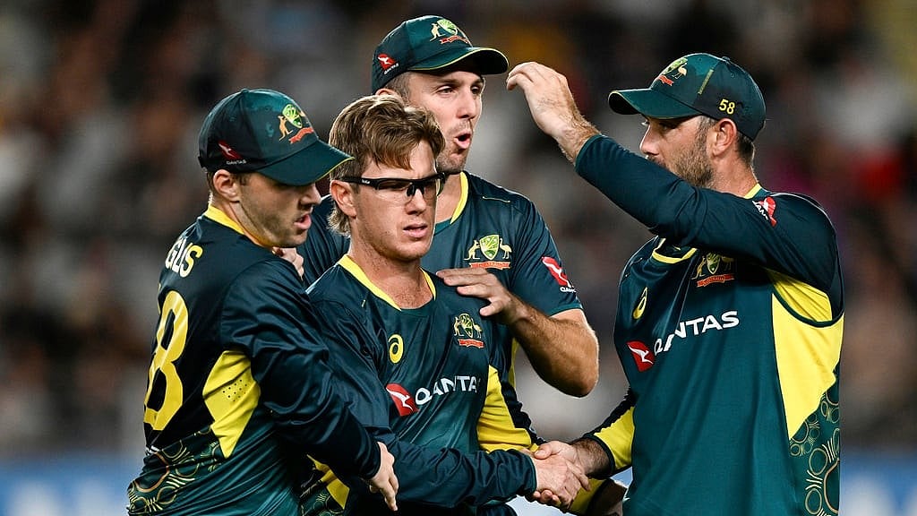 Andrew Cornaga/Photosport via AP                : Australia's Adam Zampa is congratulated by teammates after taking the wicket of New Zealand's Glenn Phillips during the second T20 international match at Eden Park in Auckland.