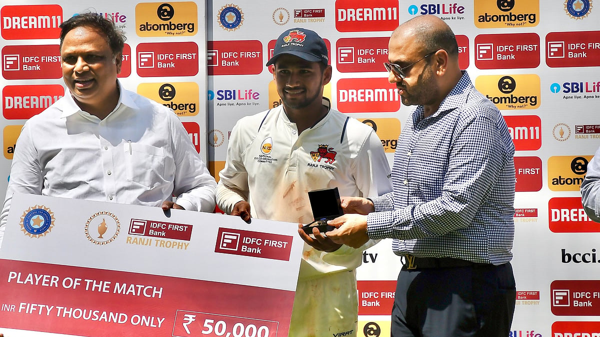 (Photo: X|Mumbai Cricket Association)  : Mumbai's Musheer Khan receives his POTM from BCCI's Honorary Treasurer, Ashish Shelar, alongside MCA President, Amol Kale for his remarkable performance in the final match of Ranji Trophy 2024 against Vidarbha. 