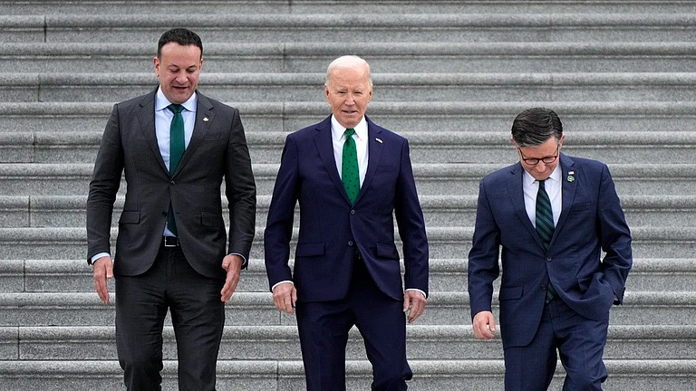 From left, Irish Prime Minister Leo Varadkar, President Joe Biden, and Speaker of the House Mike Johnson, R-La., walk down the steps following the annual St. Patrick's Day gathering at the Capitol in Washington on Friday. - AP