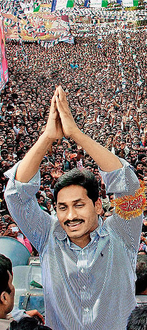 Photo: PTI : Father and Son Jagan Mohan Reddy at a public meeting